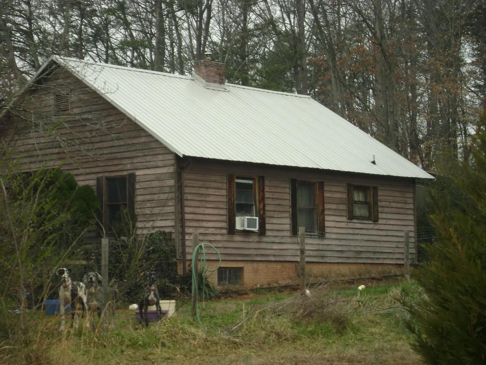 White metal roof on an old wood sided farmhouse, from a Metal Roof Installation job in North Wilkesboro